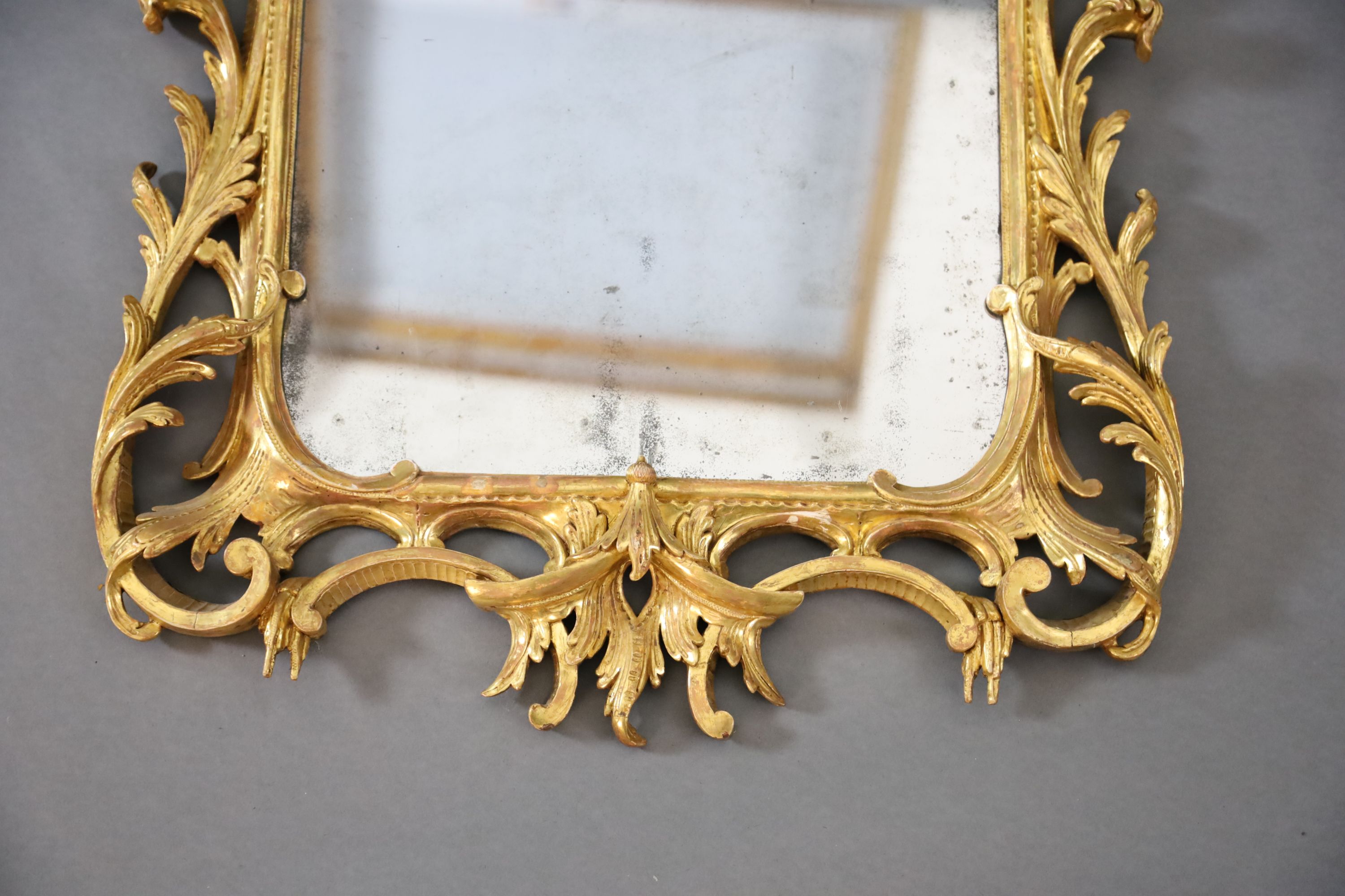 A George III Chippendale style carved giltwood wall mirror, W.1ft 10in. H.3ft 6in.